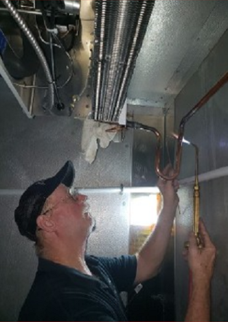 Man Fixing Air Conditioner Pipe